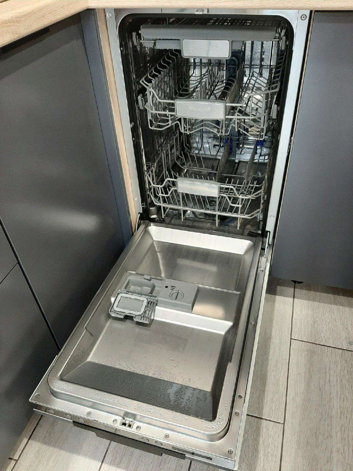 Open dishwasher with its upper and lower racks visible