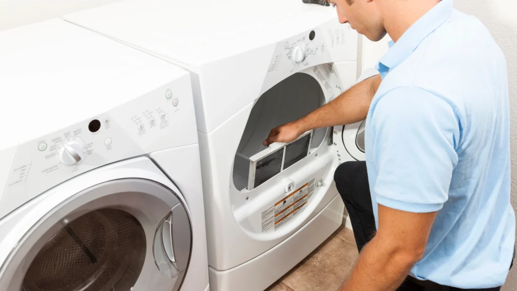 Person examining the lint-screen area of a clothes dryer