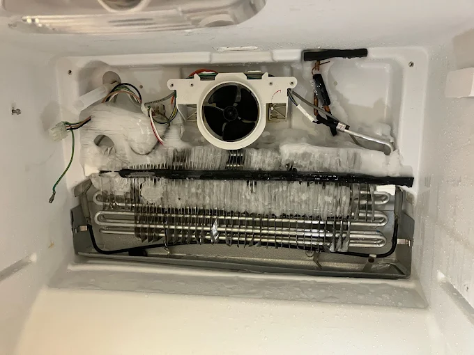 Frost buildup around an exposed freezer evaporator coil and fan